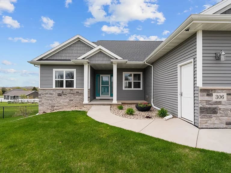 Stone-trimmed entry porch with teal front door